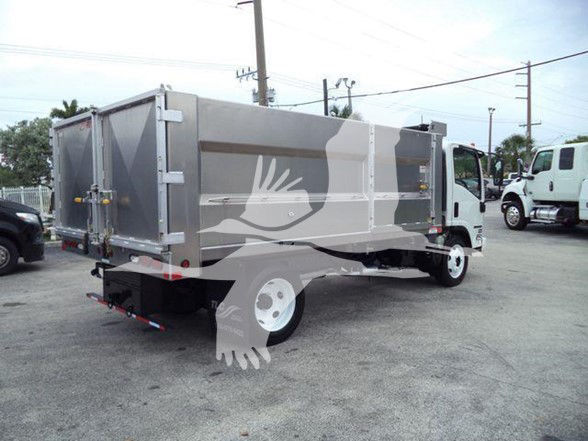 Isuzu NPR HD truck with a large gray dump body in a used truck lot, side and rear views visible.