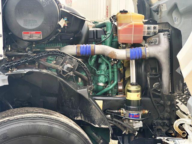 Volvo VNL 670 engine bay showing coolant reservoir, turbo hoses, and auxiliary components