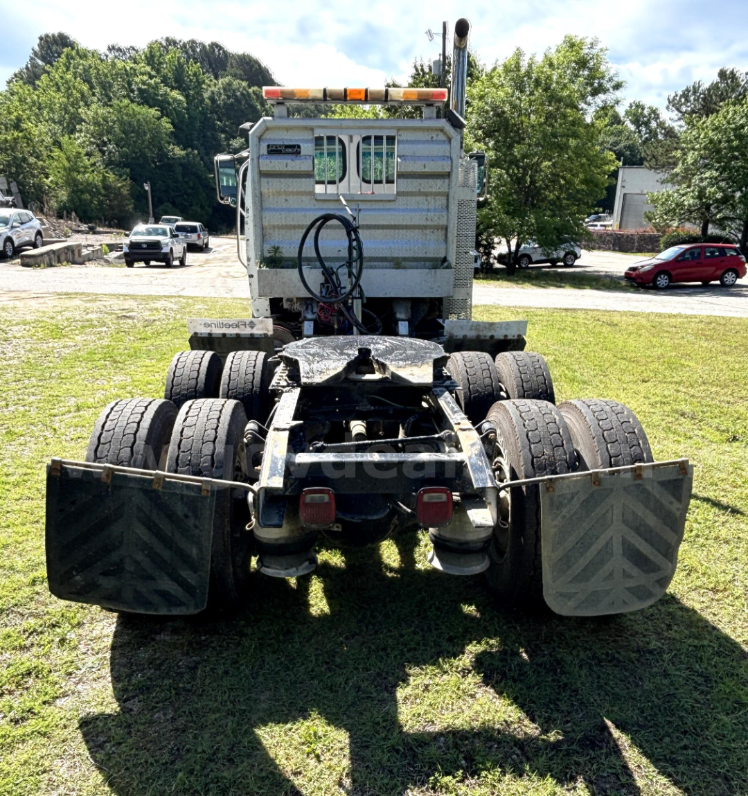 Rear view of a 2009 Sterling LT9500 cab and chassis showing dual rear axles, fifth-wheel area, and mud flaps.