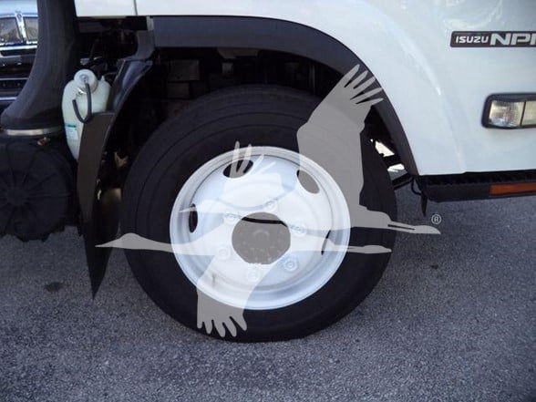 Isuzu NPR HD truck front wheel well and fender with logo visible