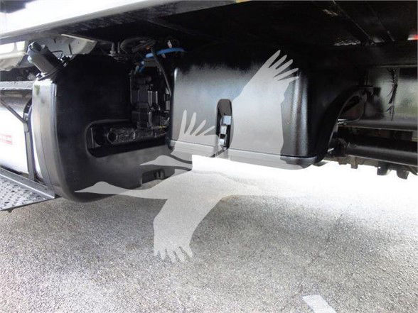 Underbody view of a 2015 Freightliner Business Class M2 106 flatbed truck showing fuel tank and chassis components.