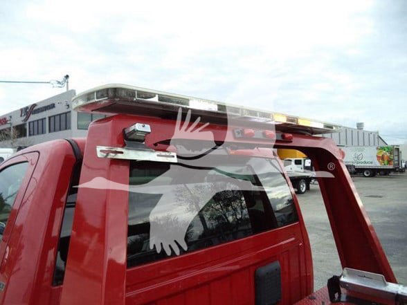 TowTruck-style Ram pickup with a roof-mounted light bar and visible rear window; red truck bed with chrome accents.