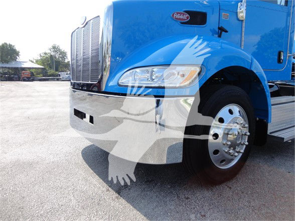 Blue 2022 Peterbilt 337 front-left view showing chrome bumper, headlight, grille, and side mirror with wheel and front tire.