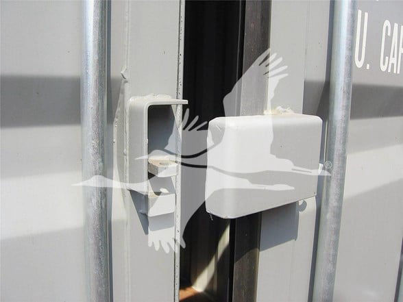 Container trailer door latch with U.S. CARGO text on the side.