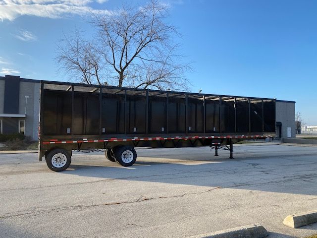 2008 Transcraft 48 ft crush car carrier trailer side view showing open-top cargo bed and dual rear wheels.