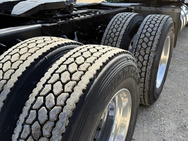Dual rear axle tires with tread pattern and sidewall branding visible in a truck chassis.