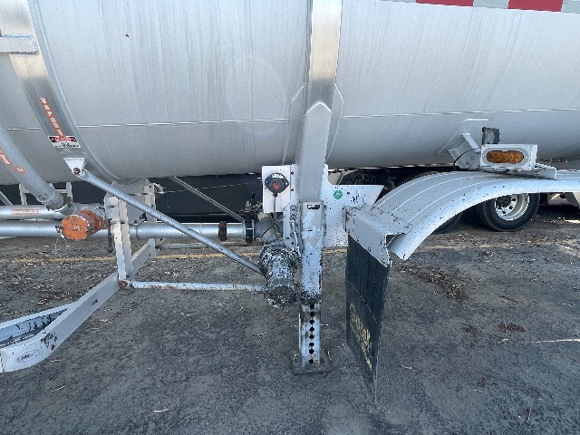 Trailer hitch area of a 2011 Heil 407 crude oil trailer showing landing gear, frame, and hoses.