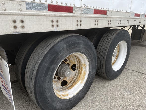 Wabash dry van trailer wheel set showing dual tires and rims with some rust on the inner wheel hub.