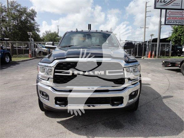 Front view of a 2024 Ram 4500 SLT truck in a dealership lot with RAM grille and chrome bumper.