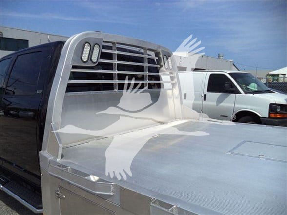Ram 5500 SLT truck front cab area with polished aluminum flatbed and headache rack.