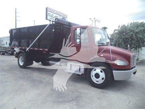 Truck in refuse service with a maroon cab and black dump body. Freightliner badge on front grille. Side mirror, wipers, and red/white reflective tape. Watermark overlay of a bird graphic obscures some details.