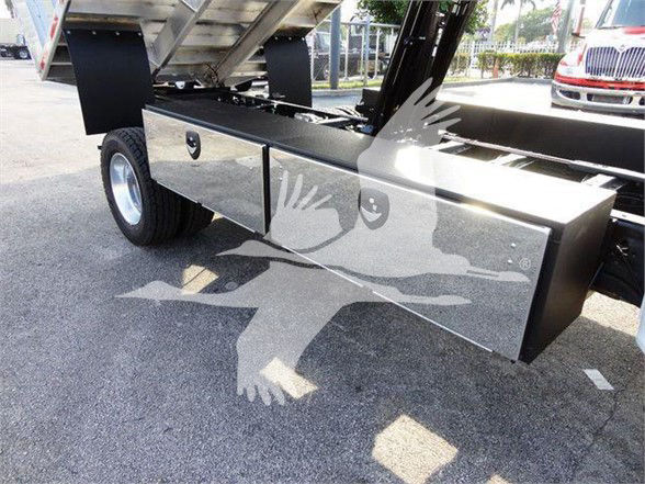 Chipper truck with a side-mounted storage box under the bed; visible text includes stock number F600CHIPPER4X4.