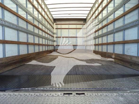 Truck bed interior with metal side rails and wooden planks; watermark of a stylized running figure across the image.