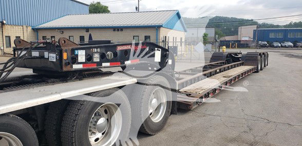  Fontaine 55 Ton lowboy trailer with drop side rails, dual rear axles, and hydraulic gooseneck visible; stock plate and decals on front.