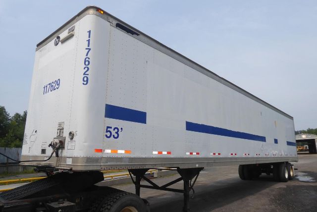 Great Dane trailer showing side and rear with 53' length, blue stripe graphics, wheel axles, and serial numbers visible.