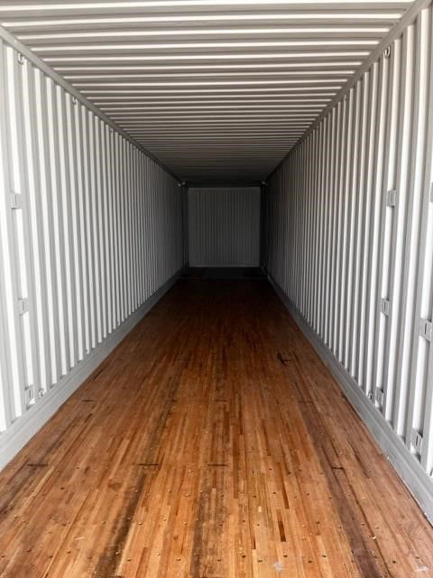 Interior of a 53ft CIMC intermodal dry container with wooden floor, corrugated steel walls, and ceiling; empty cargo space.