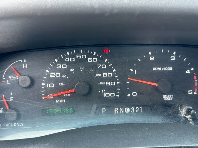 Dashboard of a 2004 Ford F-550 displaying speedometer up to 100 mph, tachometer up to 6, RPM x1000 label, gear indicator P R N D 3 2 1, odometer 159,4196? and warning icons.