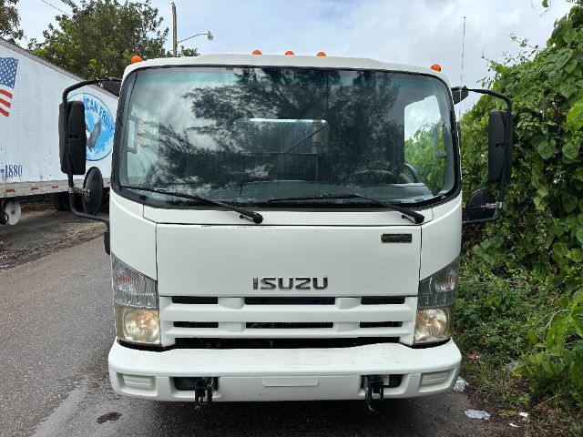 Isuzu NPR-HD swept-back cab front view with white paint, large windshield, headlights, and front bumper; orange marker lights on roof; side mirrors visible.