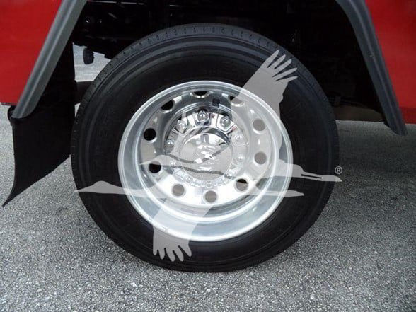 Wheel/rim of a red 2021 Ram 4500 SLT tow truck showing alloy wheel and tire.