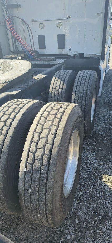 Kenworth T680 heavy truck rear dual axle tires and chassis with fifth wheel area visible.