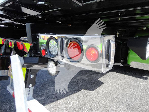 Peterbilt 337 tow truck rear with taillights and bumper plate visible under truck chassis.