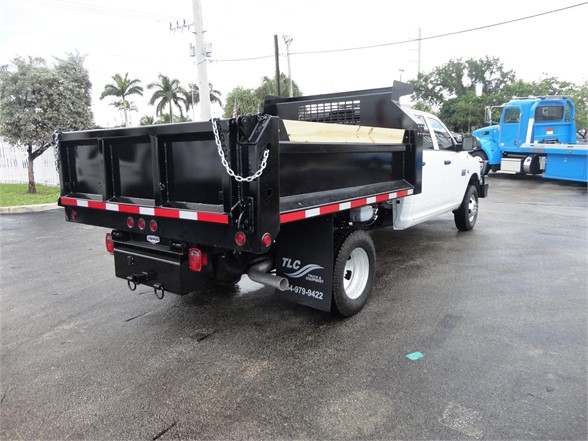 2012 Ram 3500 SLT dump truck rear/right view showing dump bed, chains, and rear bumper with TLC logo.