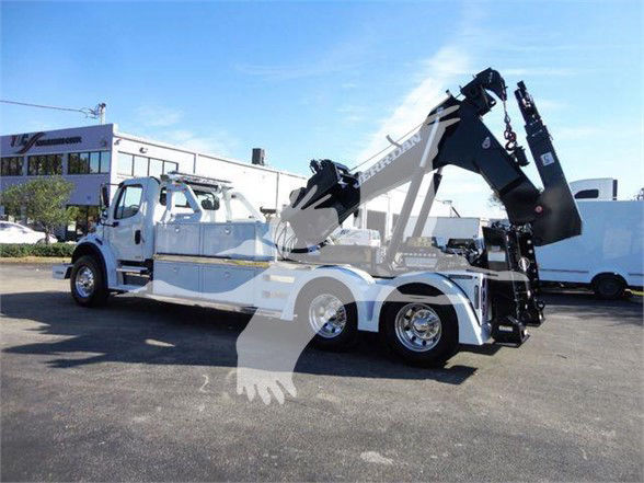2012 Freightliner Business Class M2 106 tow truck with two hydraulic cranes mounted on the frame, dual rear axles, white with chrome wheels.