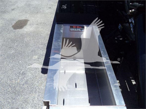 Tow truck bed/chassis showing a metal metal box or cargo bed with reinforced side walls and cutouts, Kenworth T280 stock unit in new condition.