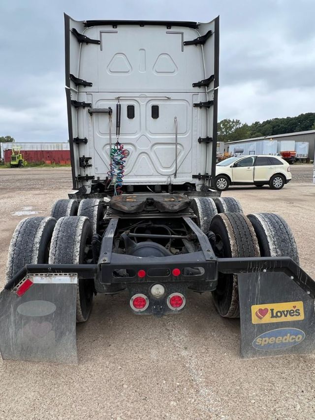 Rear view of a 2017 Freightliner Cascadia semi-truck chassis showing dual rear axles and mud flaps with Love's and Speedco logos.