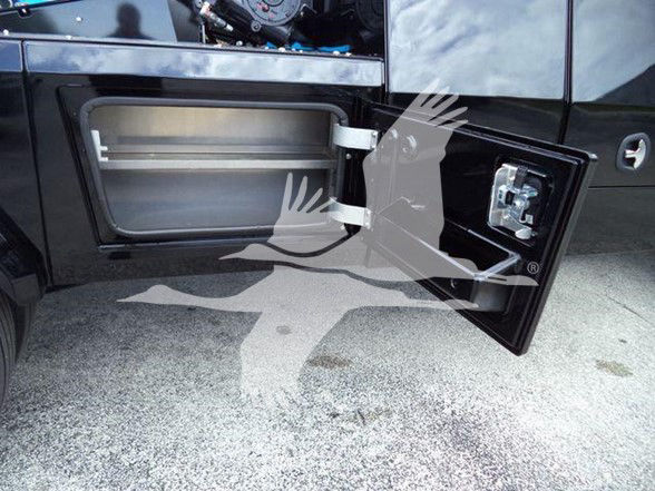 Truck side fuel/auxiliary fuel door with open panel showing interior storage compartment. Exterior door latch visible.