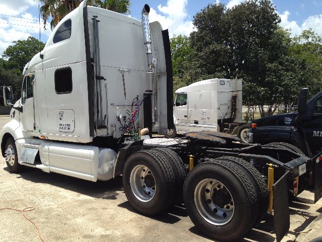 2008 Peterbilt VN urban day cab tractor showing rear dual wheels and cab side door, with fifth wheel and exhaust stack visible.