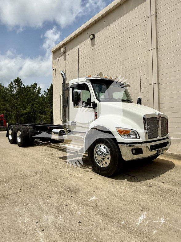 Kenworth T480 cab and chassis truck in white parked outdoors seen from front-left side with long chassis and dual rear axles.