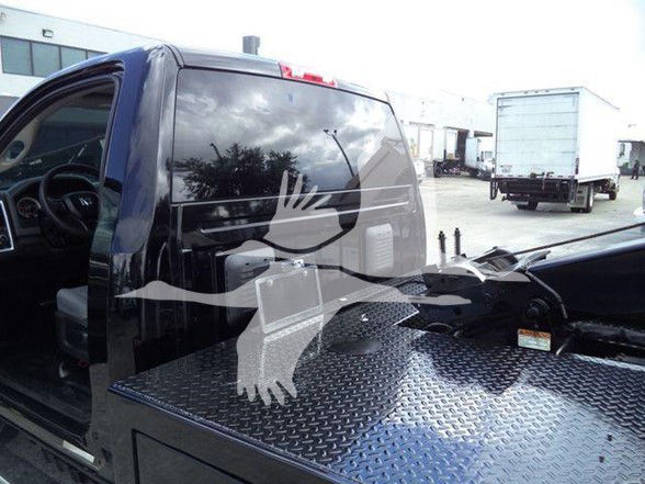 2018 Ram 4500 SLT pickup truck with extended cab and steel diamond plate bed; side view showing cab and bed area in a dealership yard.