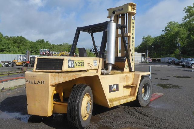 Caterpillar V225 forklift in-yard with yellow paint, exhaust stack, and large tires. Side shows V225 and CAT logo.
