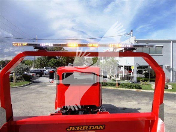 Peterbilt truck boom from rear showing red Jerr-Dan tow truck body with amber light bar on top and part of the cab.