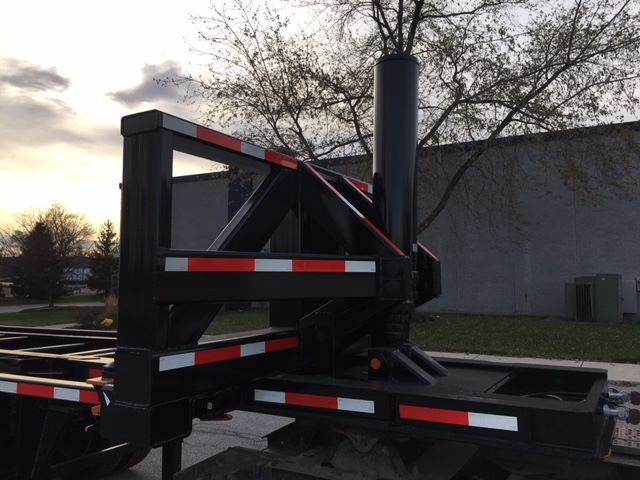 2003 Wabash tipper trailer chassis showing vertical support, black paint, red/white reflective stripes, and hitch area.
