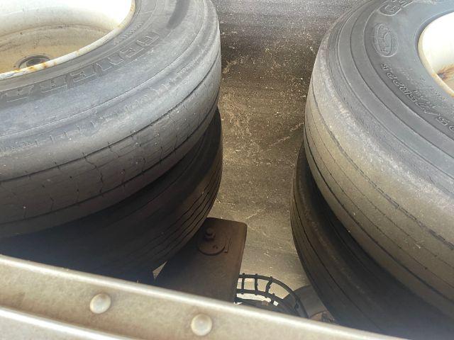 Trailer axle area with tandem rear wheels showing dual tires and frame clearance; no readable labels or stickers visible.