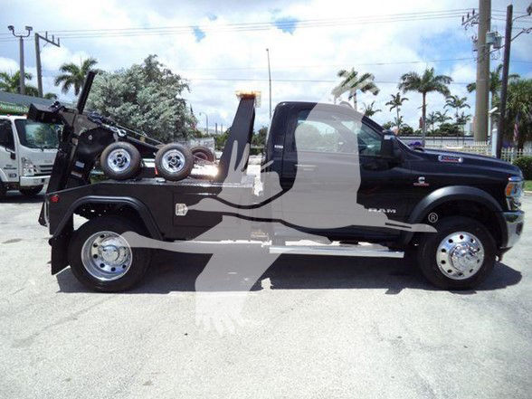 2024 Ram 5500 SLT tow truck side profile showing flatbed with wheel-lift hoist and dual rear wheels.