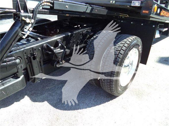 Truck chassis and rear wheel area of a 2023 Chevrolet Silverado 6500HD showing suspension and wheel with tire, undercarriage components visible.