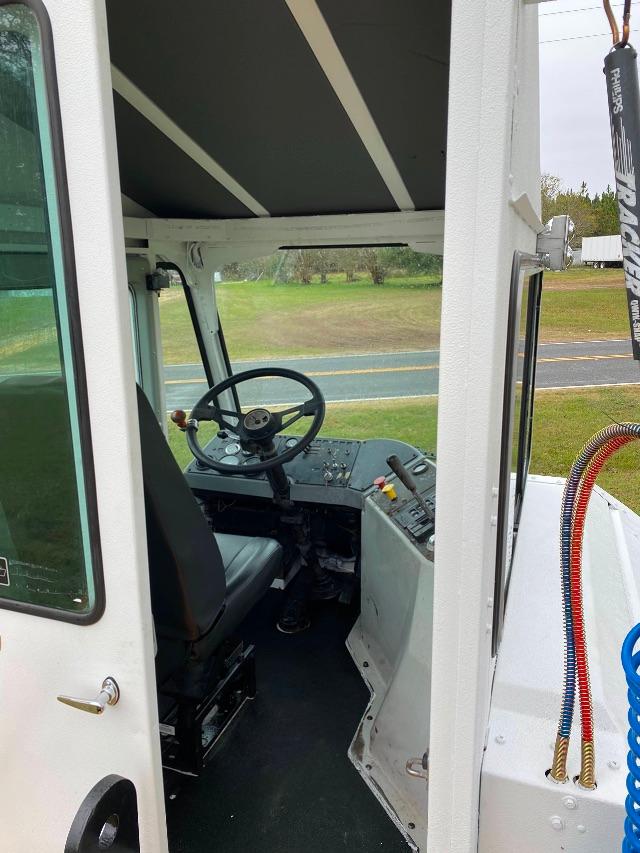 Operator cabin of a 2011 Kalmar Ottawa 4x2/yT50 yard truck showing steering wheel, control panel, and entry door.