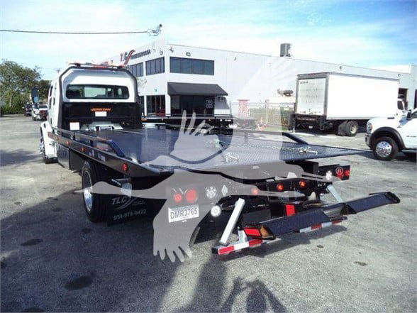 Fleet tow truck flatbed with Freightliner M2 106 Plus; rear view shows flatbed and towing equipment; license plate  DM-? and letters on bumper.