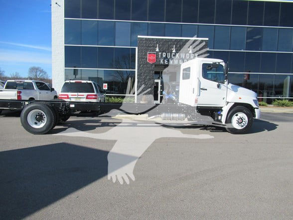 TruckWorks Kenworth dealership cab and chassis with a white Hino L6 cab and a long wheelbase frame.