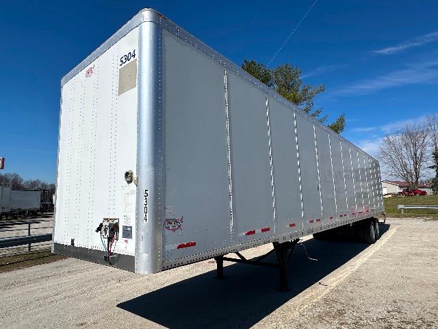 Trailer side and rear of a 2015 Wabash DuraPlate dry van trailer, white with silver corner posts, VIN tag and stock number visible.