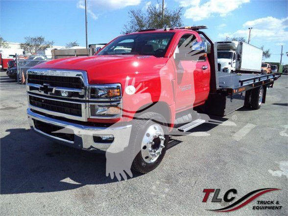 Chevrolet Silverado 6500HD tow truck in red, front three-quarter view with flatbed; TLC Truck & Equipment watermark.