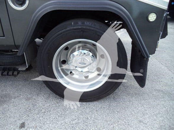 Ford F-450 front wheel and fender view showing steel wheel and tire.