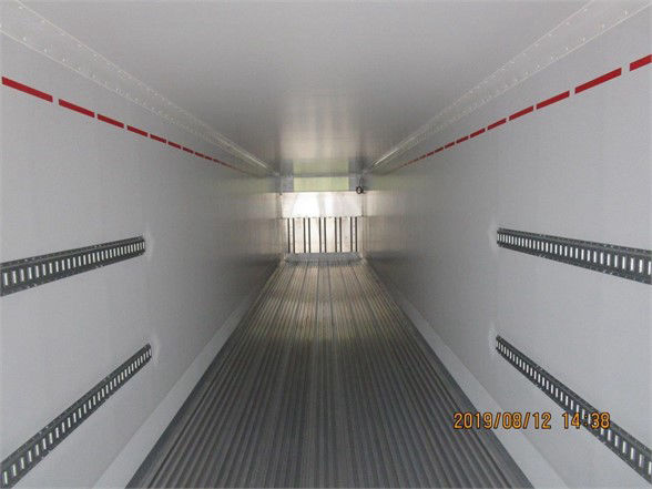 Interior of a CIMC refrigerated container trailer showing clean aluminum walls with red strap markings and ribbed side rails; date stamp bottom right.