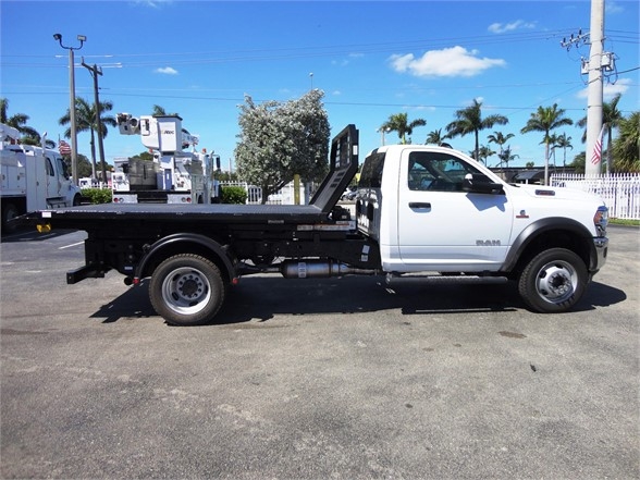 2013 Ram 5500 HD hooklift truck side profile showing long flatbed and wheelbase.