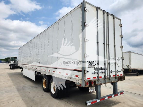 Great Dane trailer in a storage yard showing side and rear with white body, dual rear doors, and registration numbers on the back.