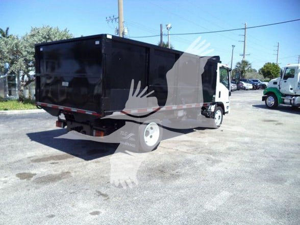 Isuzu NPR HD dump truck rear and side view showing a black dump bed and white cab.