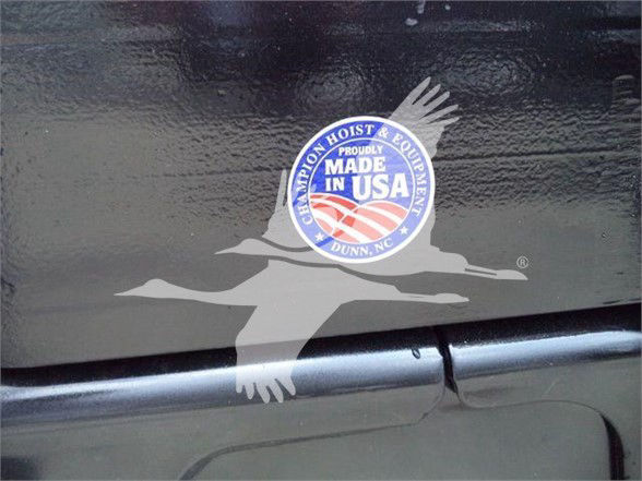 Sticker decal of a flying goose with American flag colors on a Ford F-550 truck body and seam line.
